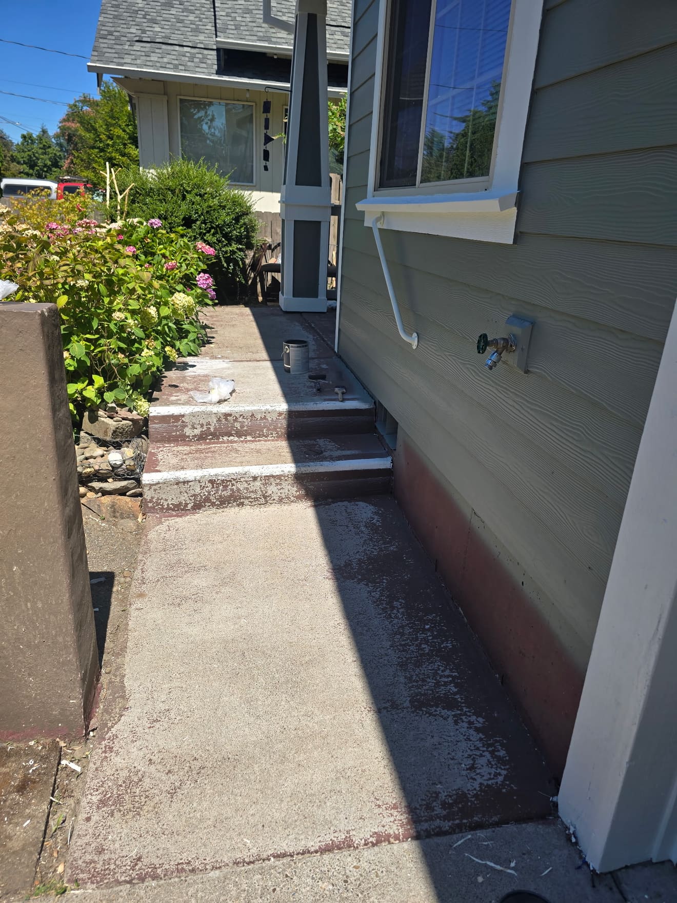 Front walkway and steps before coating — stained bare concrete