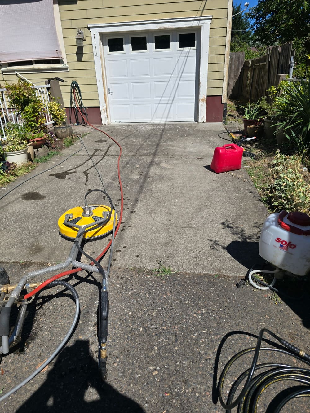 Pressure washing a driveway and siding before exterior painting in Beaverton, OR