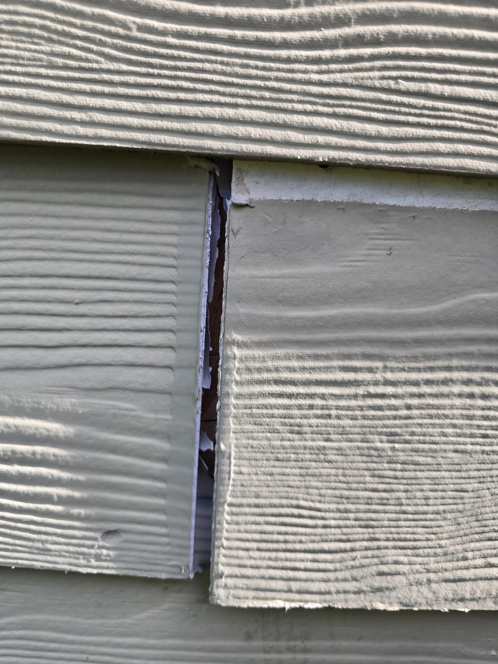 Gap in lap siding sealed and prepped before painting