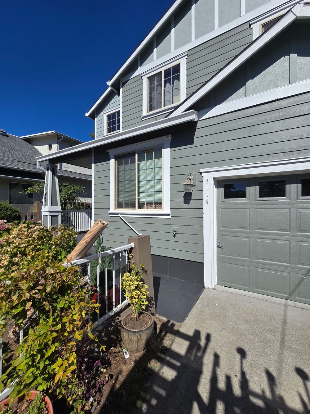 Repainted garage and front elevation in gray with white trim