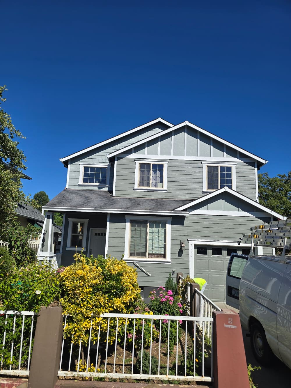 Finished exterior repaint of a Beaverton home — gray siding with white trim